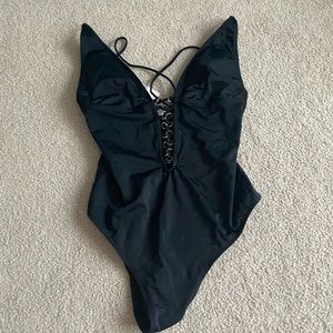 Black one piece with strappy back. NWT!